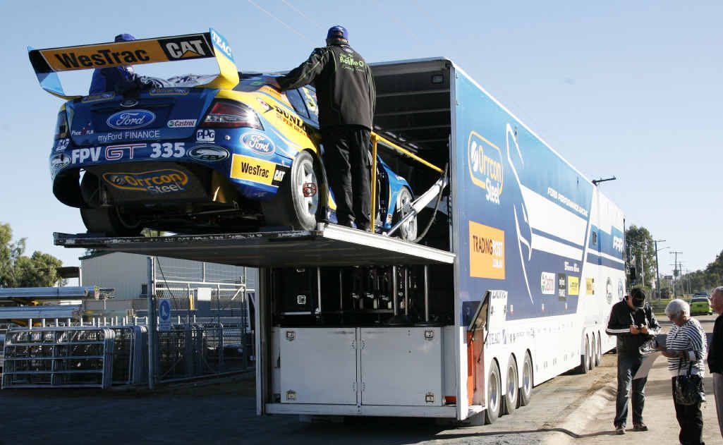 The V8 Supercar gets carefully loaded onto the truck. The V8 Supercar gets carefully loaded onto the truck.